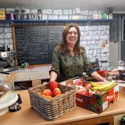 Marlene, behind the counter at The Village Shop in West Marton