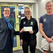 Customer Consultant at Settle branch, Lisa Beck with Miss Newbould and Mr Harrison receivign their £500 cheque on behalf of Settle College PE Department