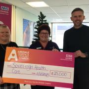 Nicola Denbow, Matron, Airedale ED Department (centre) receiving a cheque from Barbara Keiss and Neil McCallum from Sovereign Health Care