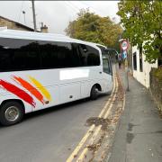 A Coach negotiating the tight turn onto Rectory Lane
