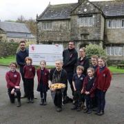 The cheque is handed over to Burnsall school
