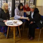 Members of Farnhill and Kildwick Local History Group selecting items for the archive exhibition