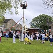 Children dance around the Maypole at Long Preston’s annual Mayday celebration.