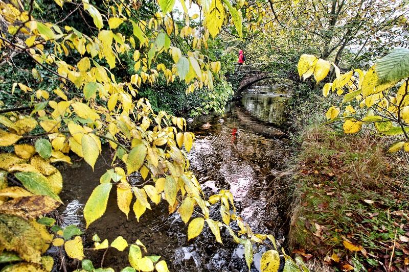 Autumn colours frame Little Emily's Bridge on the original church path from Threshfield
