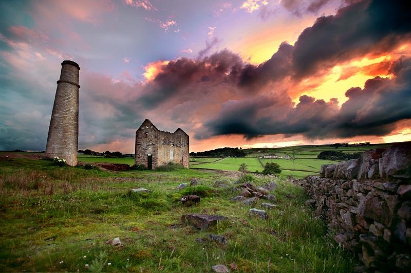 Dramatic cloud formations and firey skies provide a dramatic backdrop to the old lead mine buildings at the Gib, Cononley.