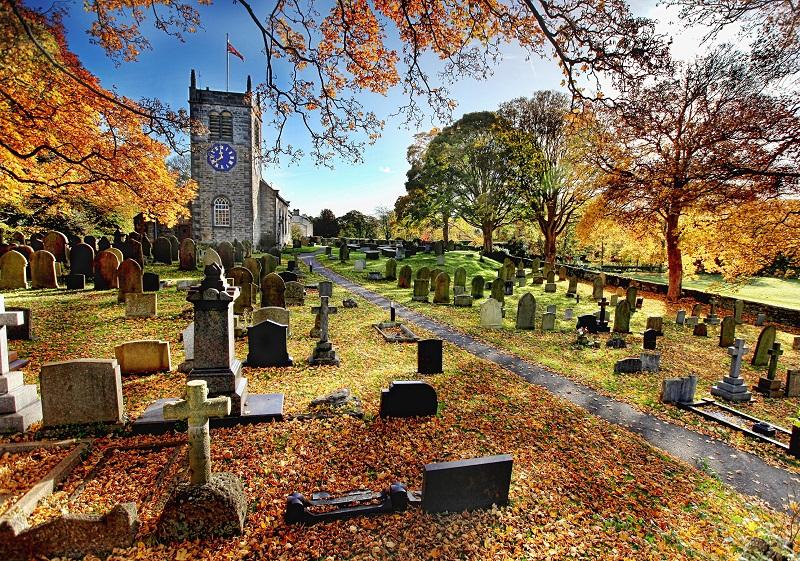 A golden carpet of autumn leaves and trees frame the ancient church of St Peter’s Addingham. 