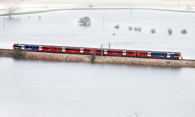 A train cuts a lonely figure as it cuts through a temporary lake, produced by flood water on the Aire Valley near Cononley.