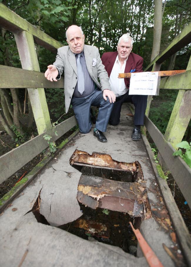 Councillors John Kerwin-Davey and  Robert Heseltine, who are angry at the damage caused to the bridge at The Ginnel in Skipton