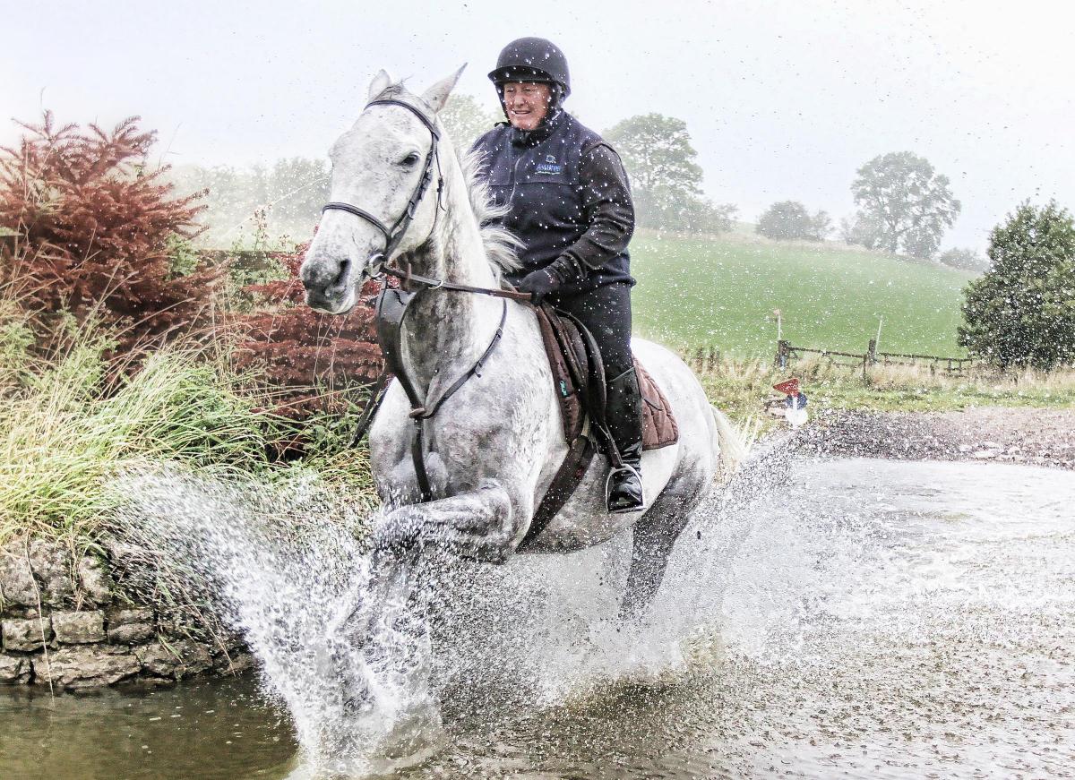 The toned definition of  thoroughbred grey Flouraclock ridden by Wendy Wild and the dramatic spray  as the horse powers through a stream makes for a fascinating image. The picture was taken at Craven Country Rides in Coniston Cold