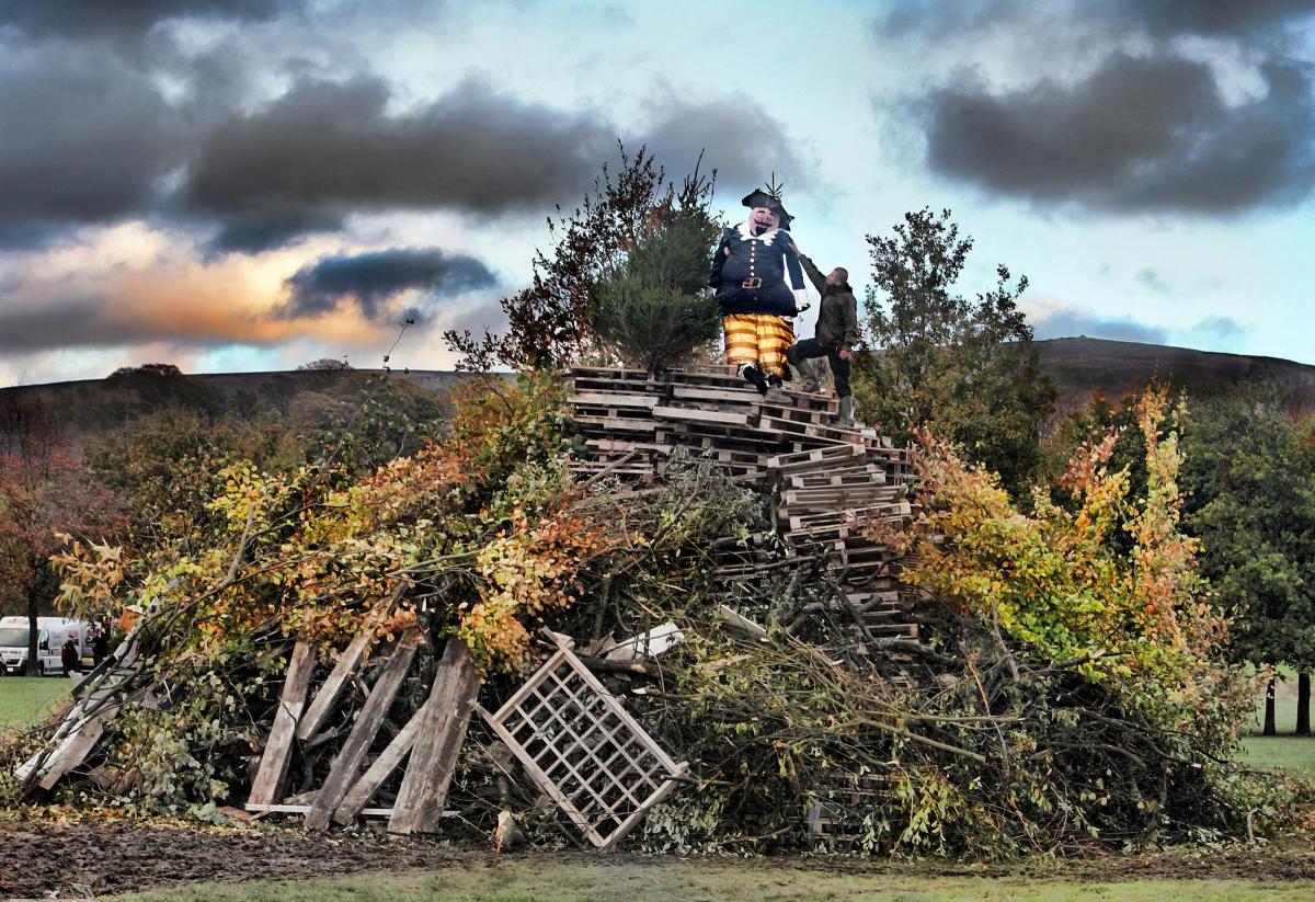 Estate worker Lukasz Sarosinski puts a 10ft high guy, made by pupils of Boyle and Petyt School, on top of a huge bonfire at the Devonshire Arms in Bolton Abbey