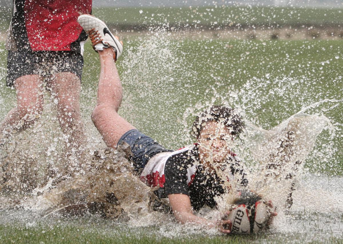 Water Splash - A female rugby player dives on the ball in the loose in appalling conditions at Skipton Rugby Club 