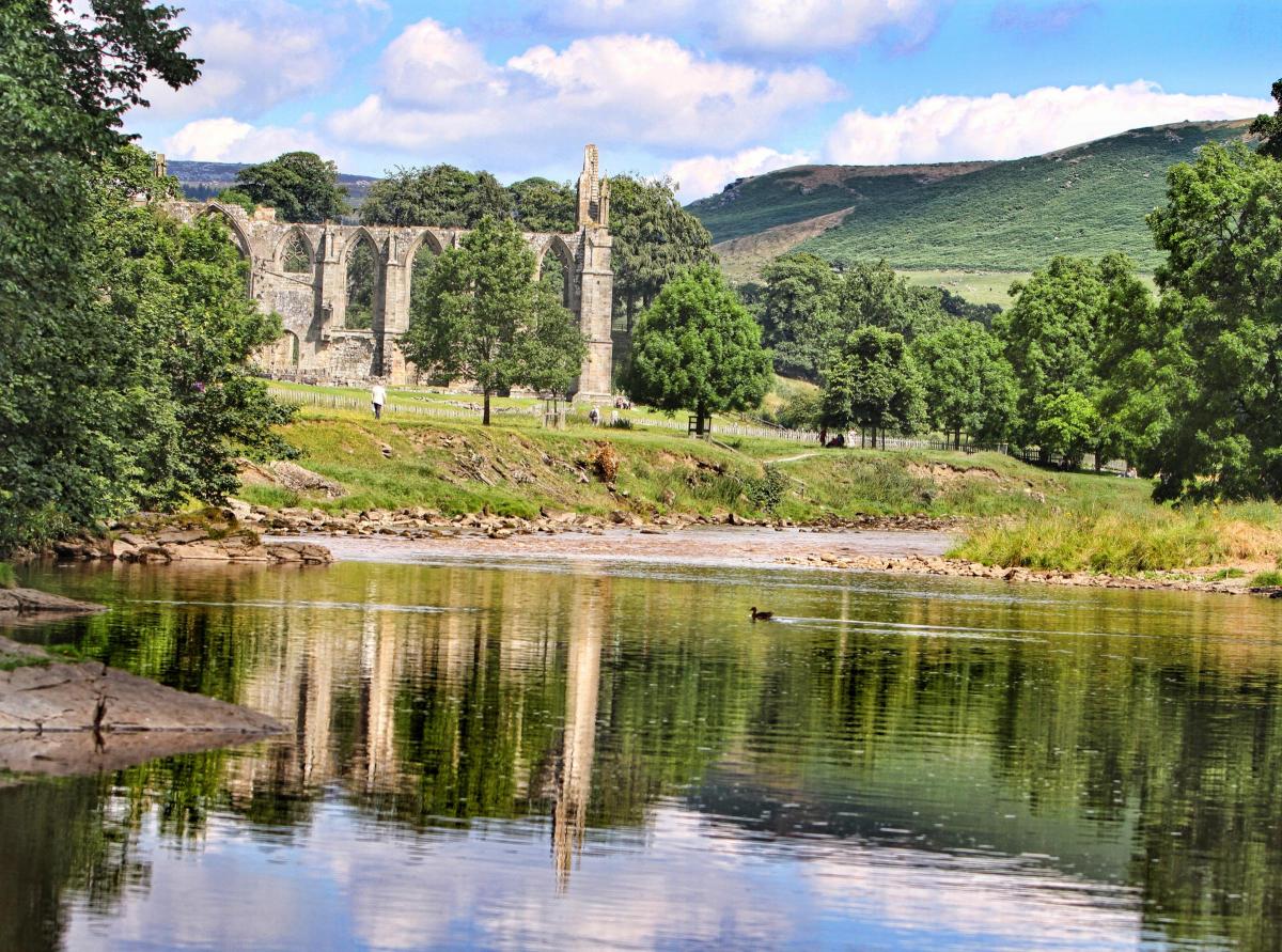 Bolton Abbey priory reflects in the River Wharfe