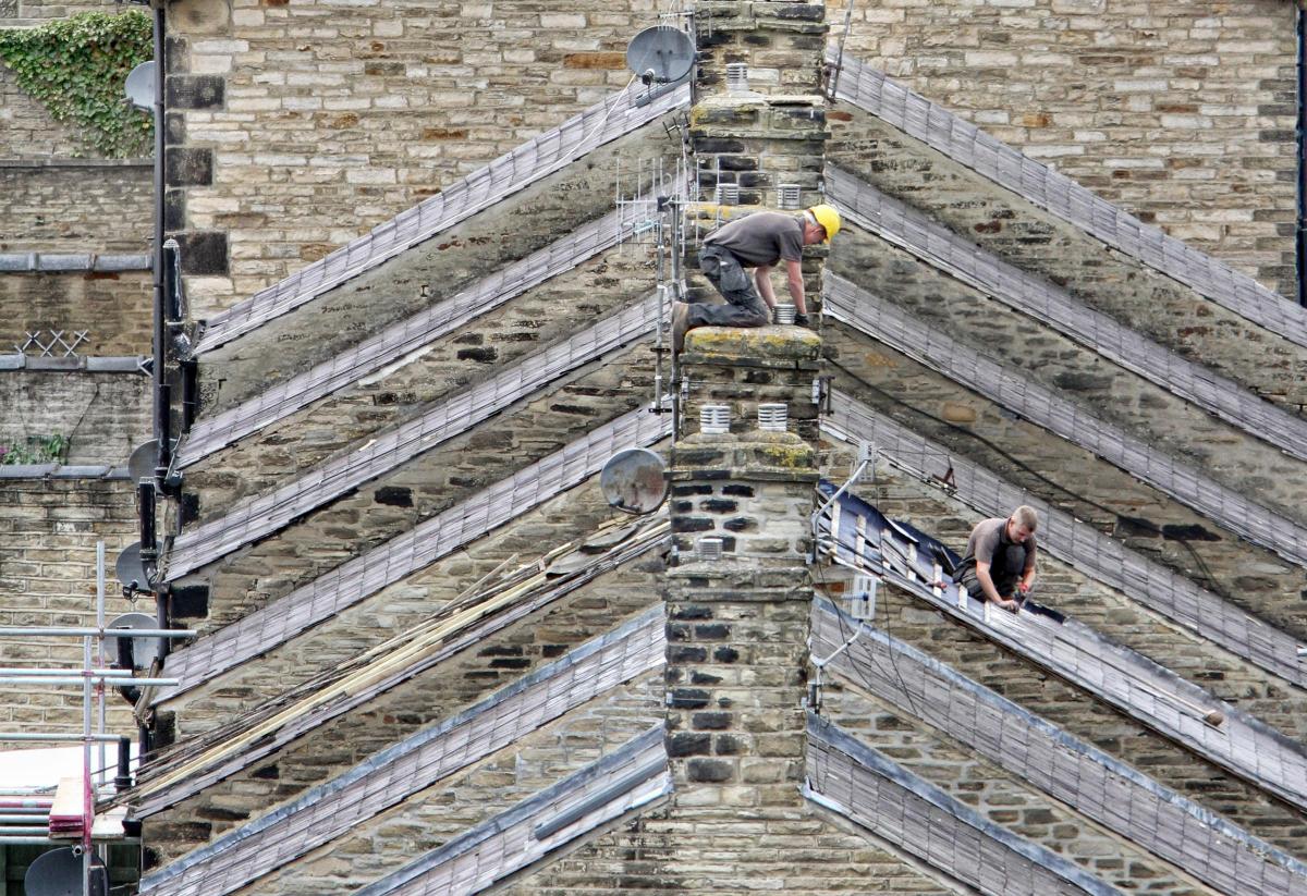 Roofers work on the  steep Victorian terraced housing in Middletown , Skipton.