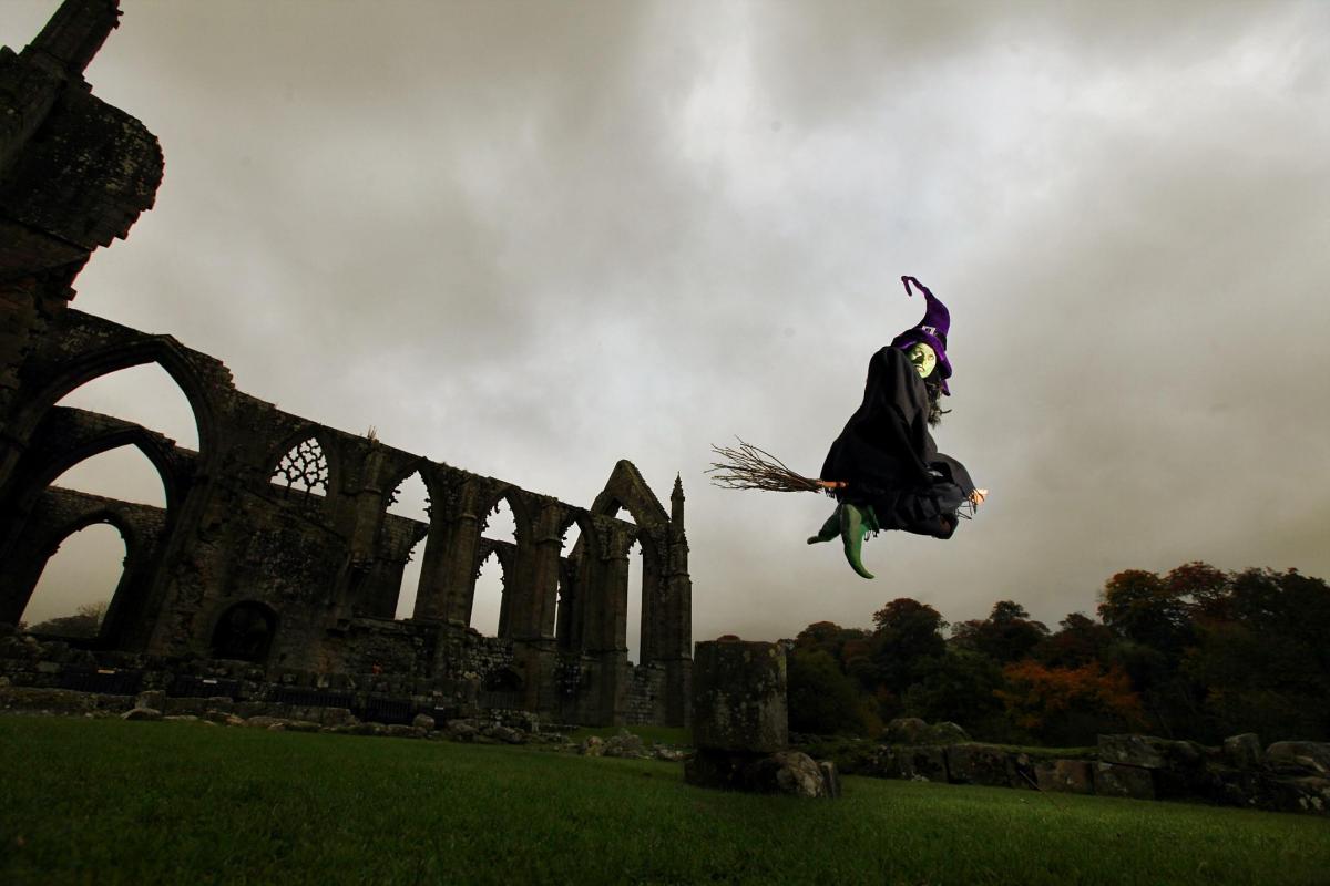 The eerie ,mystical setting of Bolton Priory provide a backdrop for a Witch on her broomstick at the launch of Bolton Abbey Pumpkin Train