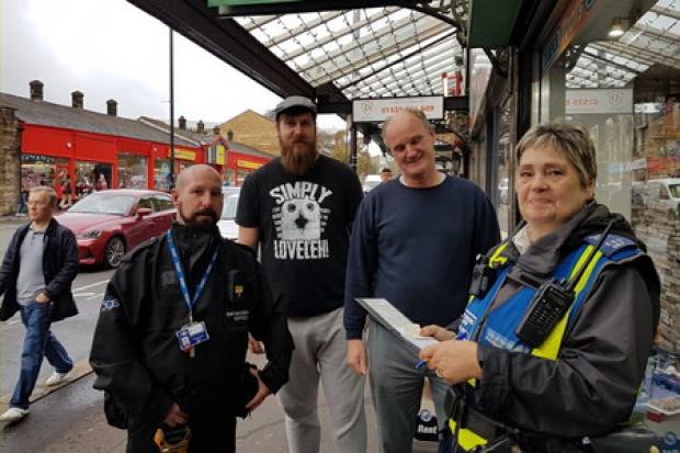 A 3GS officer and a Bradford Council warden in Cavendish Street, Keighley, with Graham Benn, second from right, and fellow trader Adam Marshall